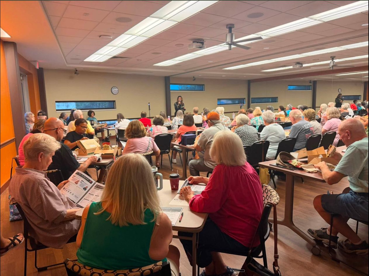 Seniors seated at tables during a free fraud-awareness workshop at the North Richland Hills senior center.